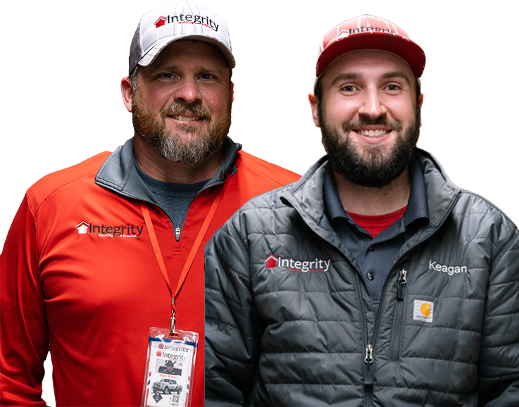 Two Integrity Roofing & Exteriors team members smiling in branded apparel